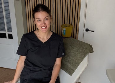 Friendly staff member at Recentre Aesthetics, Stockport, England, GB, in treatment room.