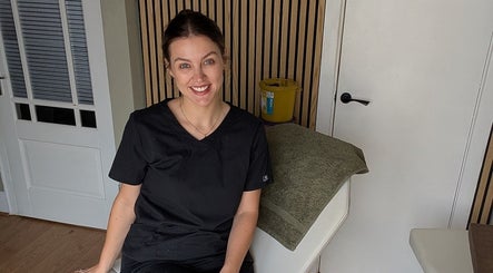Friendly staff member at Recentre Aesthetics, Stockport, England, GB, in treatment room.
