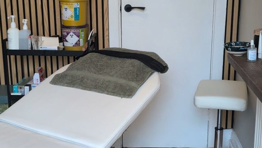 Relaxing treatment room at Recentre Aesthetics, Stockport, England, GB, features massage table and spa essentials.