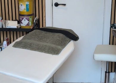 Relaxing treatment room at Recentre Aesthetics, Stockport, England, GB, features massage table and spa essentials.