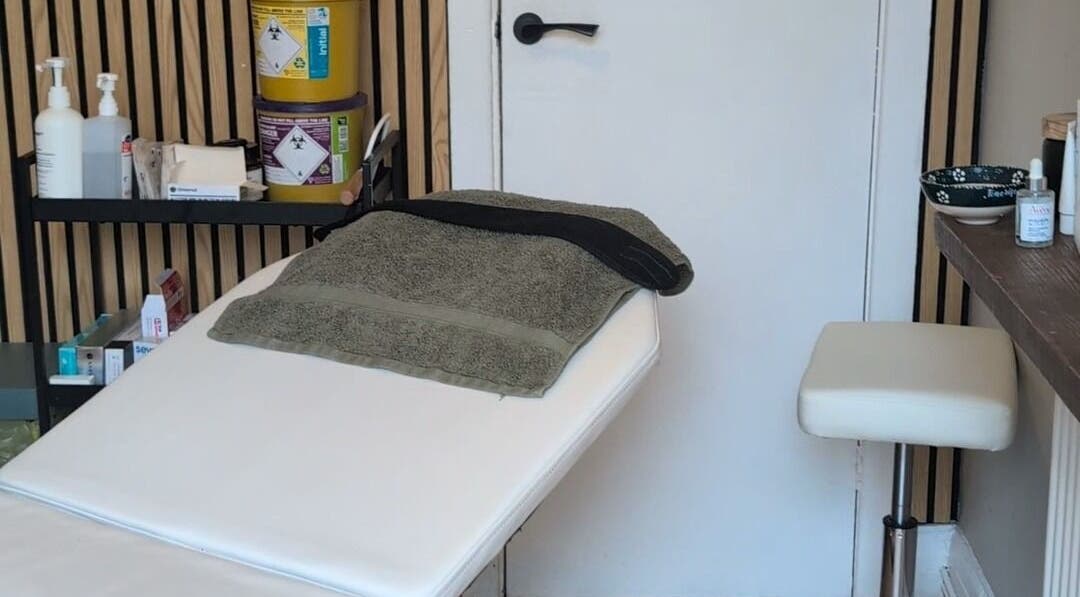 Relaxing treatment room at Recentre Aesthetics, Stockport, England, GB, features massage table and spa essentials.