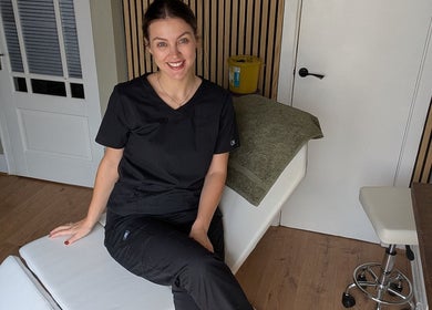 Professional at Recentre Aesthetics, Stockport, England, GB, sitting in a tranquil treatment room.