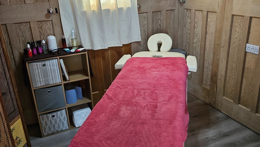 Cozy therapy room at Apple Blossom Holistic Therapies, Bournemouth, England, GB with massage table.