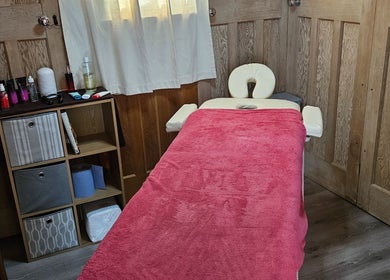 Cozy therapy room at Apple Blossom Holistic Therapies, Bournemouth, England, GB with massage table.