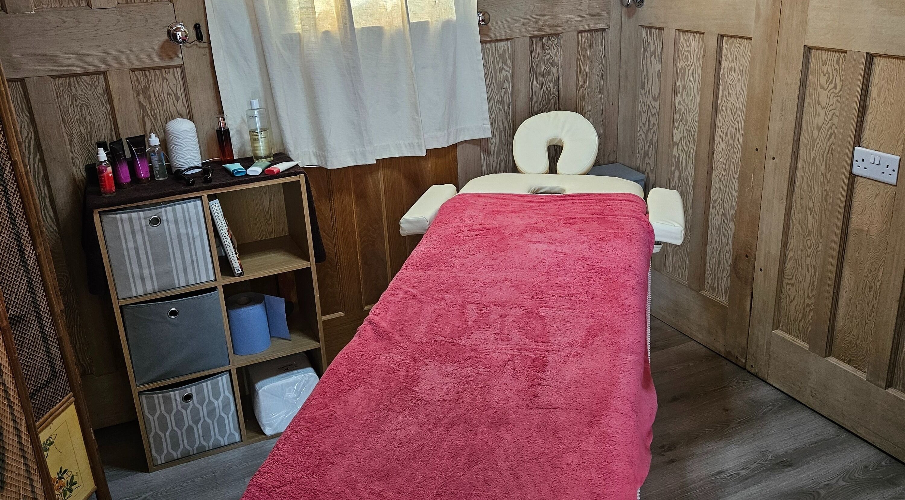 Cozy therapy room at Apple Blossom Holistic Therapies, Bournemouth, England, GB with massage table.