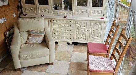 Comfortable armchair and wooden chairs in a serene corner at Apple Blossom Holistic Therapies, Bournemouth, England, GB.
