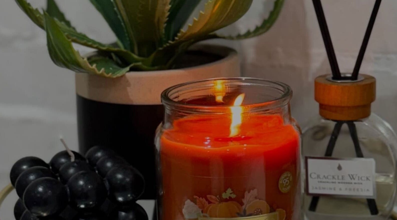 Cozy candle with plant and diffuser at Studio.19, Ixworth, England, GB, creating a warm ambiance.