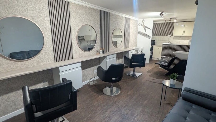 Modern salon chairs at Hair By Mel in Exning, England, GB, with stylish decor and mirrors.