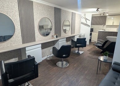 Modern salon chairs at Hair By Mel in Exning, England, GB, with stylish decor and mirrors.