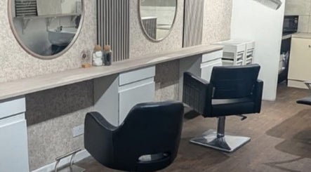 Modern salon interior at Hair By Mel, Exning, England. Features stylish seating and mirrors.
