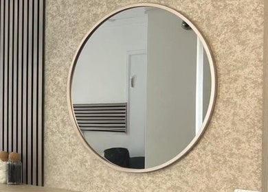 Modern round mirror at Hair By Mel, Exning, England, GB enhances salon's sleek decor.