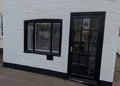 Front view of Hair By Mel in Exning, England, GB with stylish black door and window.