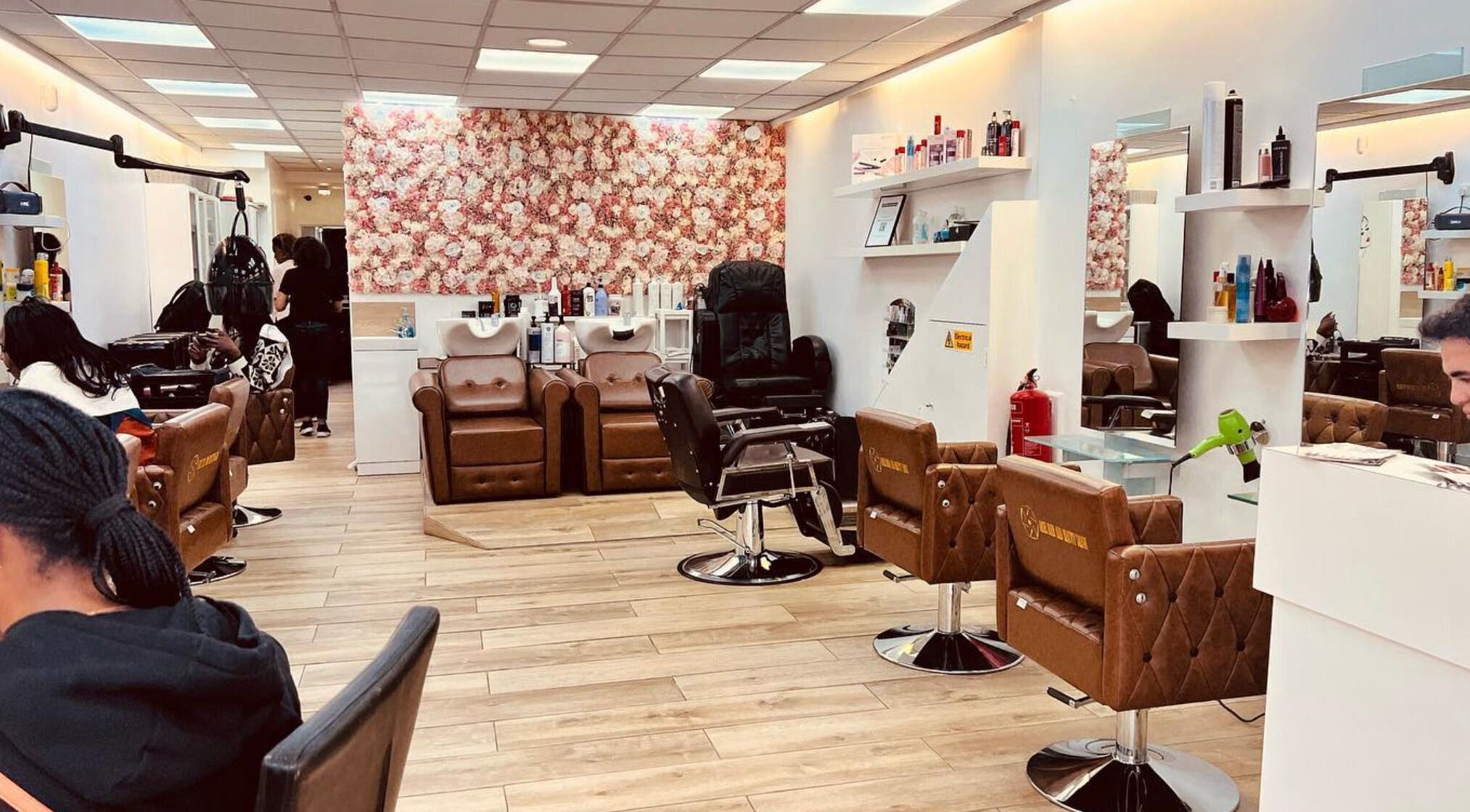 Interior view of Ariel Hair & Beauty salon, London, England, GB with stylish brown chairs and floral decor.