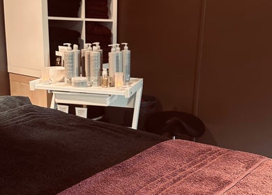 Relaxing treatment room at Ashby Woulds Beauty, Overseal, England, GB with luxurious towels and skincare products.