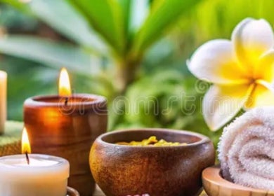 Zen spa scene with candles, plumeria, and rolled towel at Dessa Therapist, Grantham, England, GB.