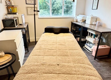 Cozy treatment room at Beauty by Jessica in Cheltenham, England, GB, featuring a plush bed and tranquil decor.