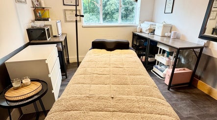 Cozy treatment room at Beauty by Jessica in Cheltenham, England, GB, featuring a plush bed and tranquil decor.