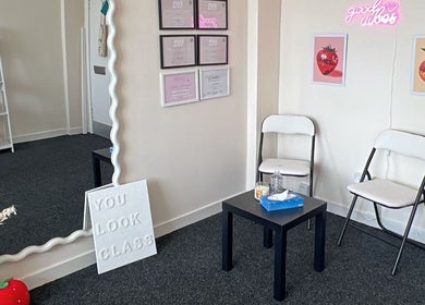 Bright waiting area at Embody Beauty, Clydebank, Scotland, GB with decor and seating.