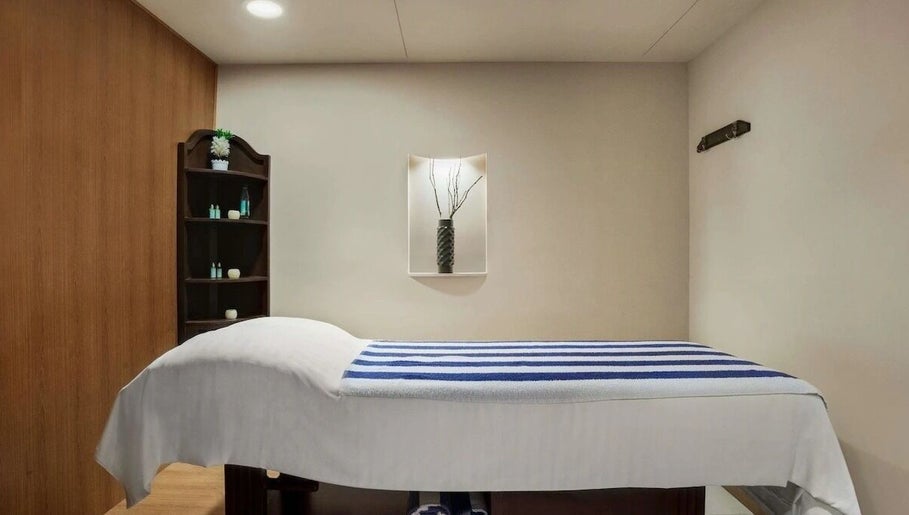 Tranquil massage room at Massage Center Spa Karachi in Karachi, Sindh, PK with a neatly made massage bed.