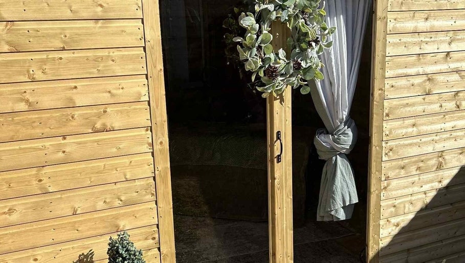 Charming wooden door with foliage wreath at The Massage Room, Atherstone, England, GB.