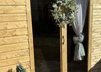 Charming wooden door with foliage wreath at The Massage Room, Atherstone, England, GB.