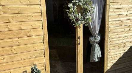 Charming wooden door with foliage wreath at The Massage Room, Atherstone, England, GB.