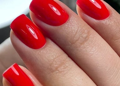 Close-up of vibrant red manicure at Beauty Studio Madam D, București, București, RO showcasing stylish design.