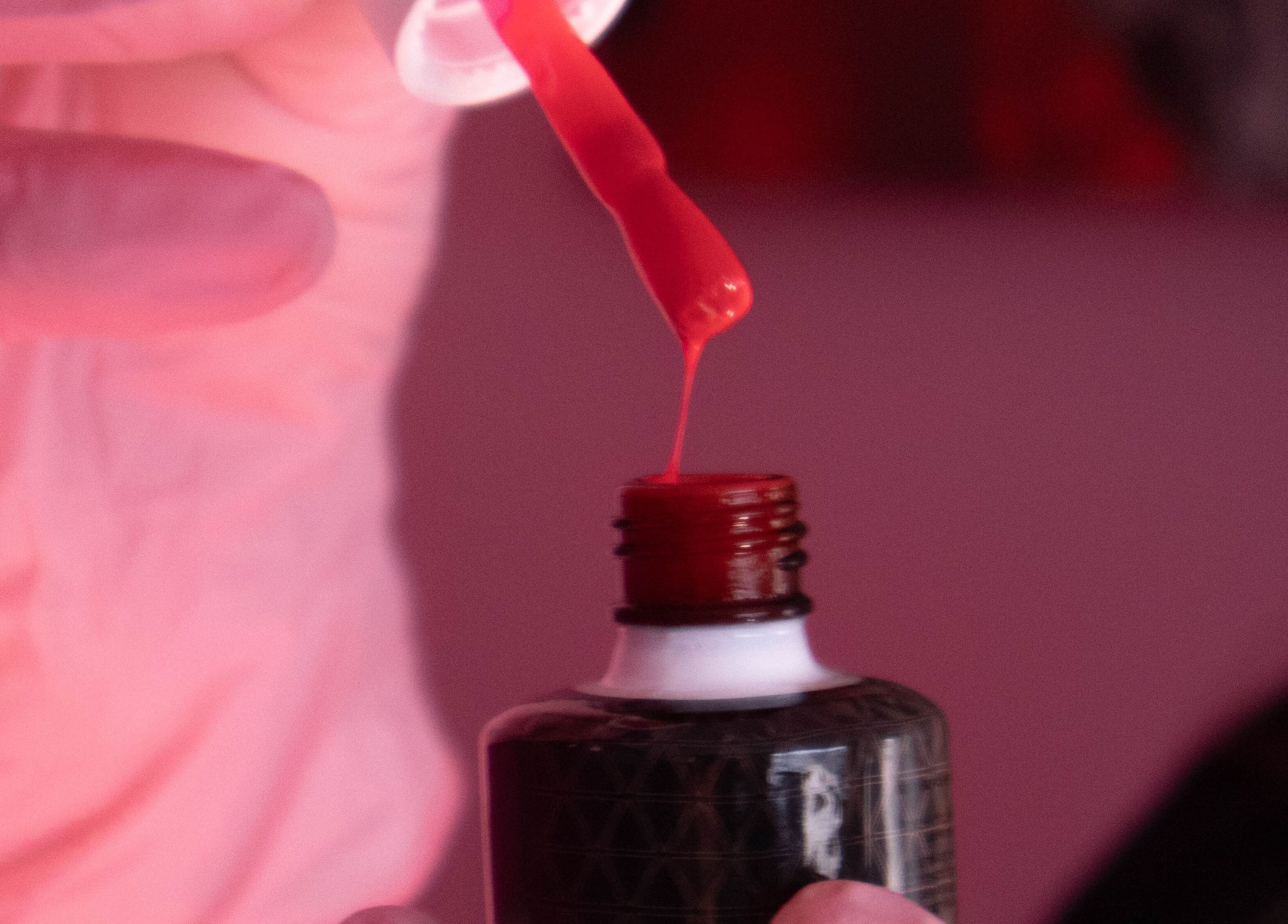 Red nail polish being prepared at Boss Babes Beauty Lounge, Cape Town, Western Cape, ZA.