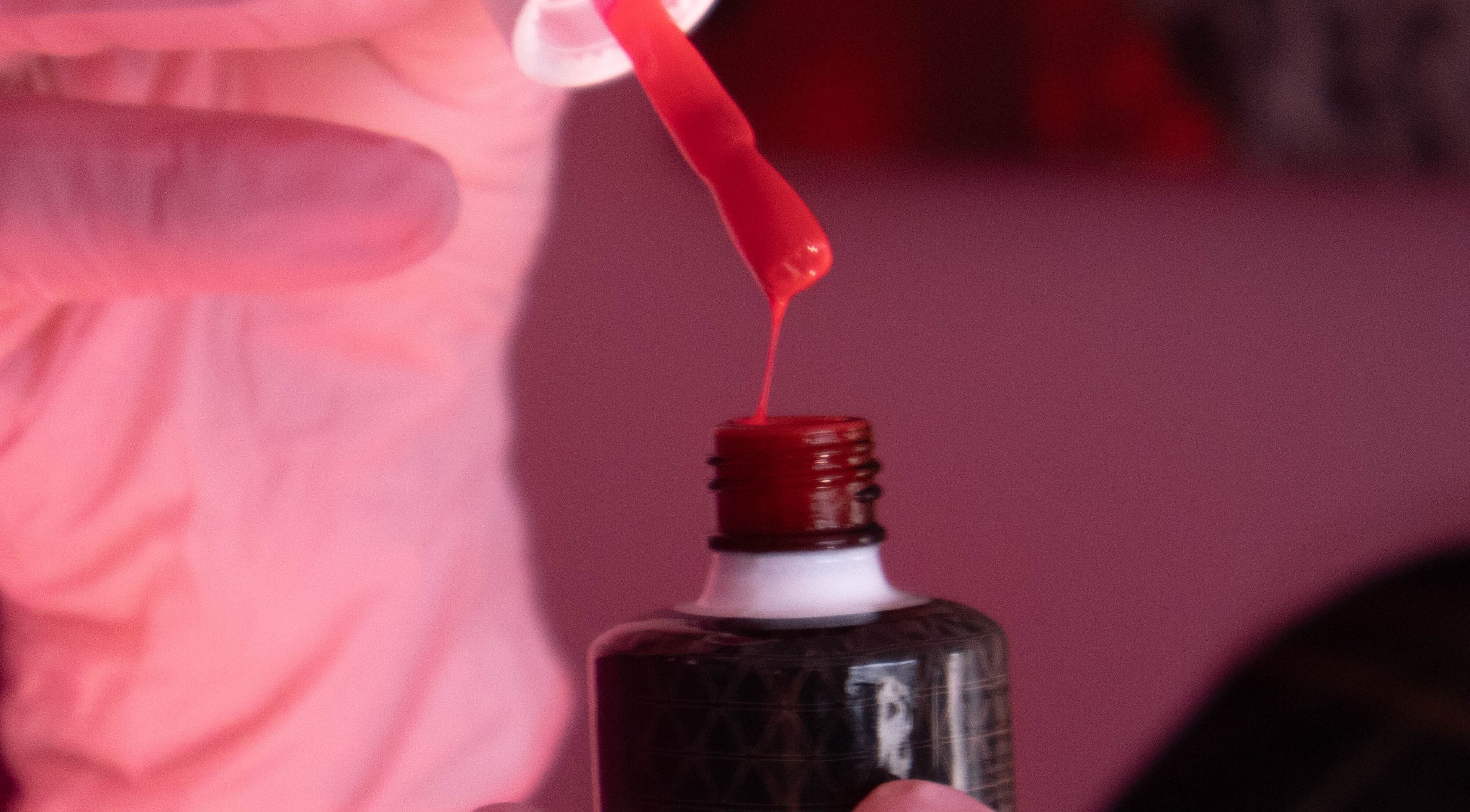 Red nail polish being prepared at Boss Babes Beauty Lounge, Cape Town, Western Cape, ZA.