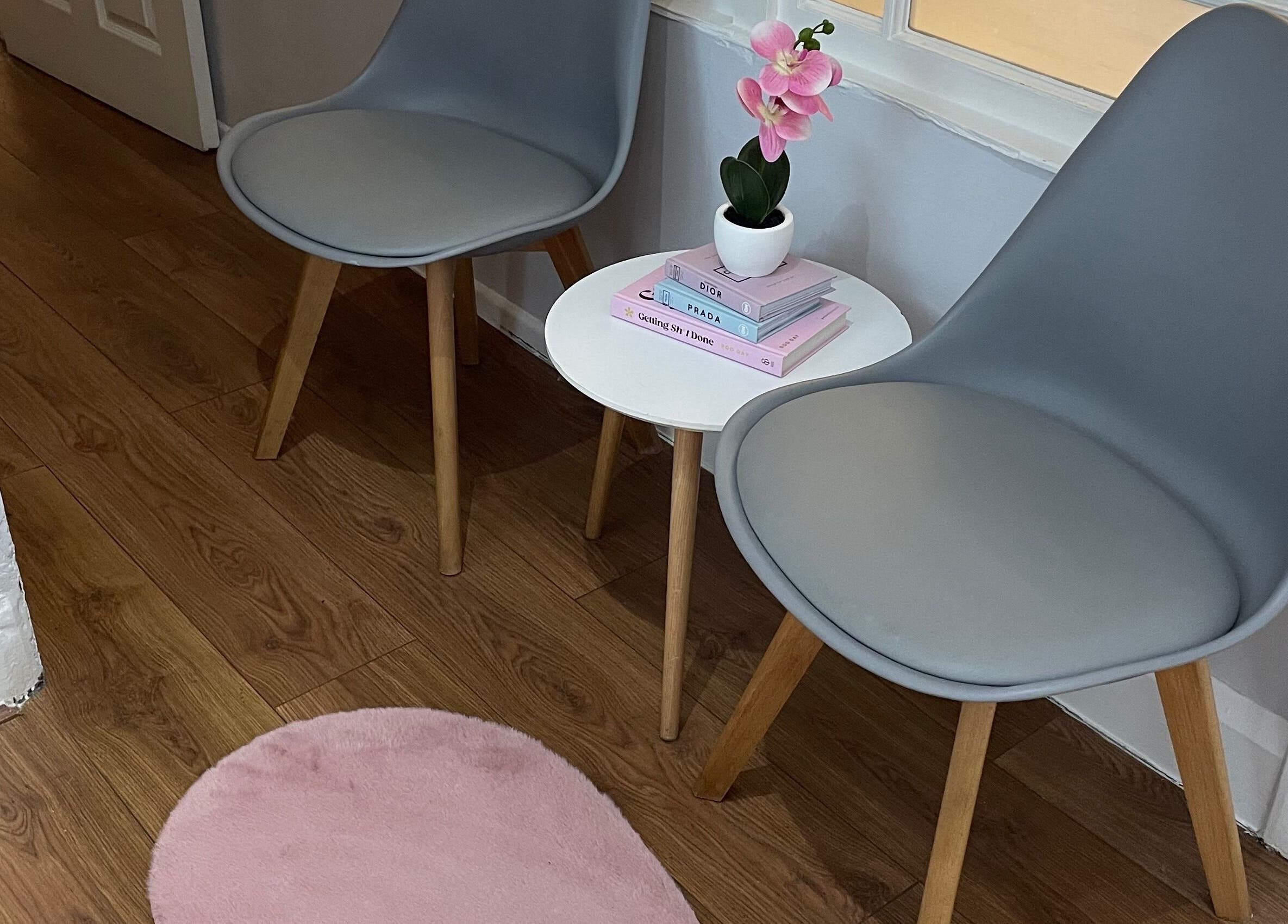 A serene waiting area at Nails by Kate Kennedy in Huddersfield, England, GB with chairs and a small table.