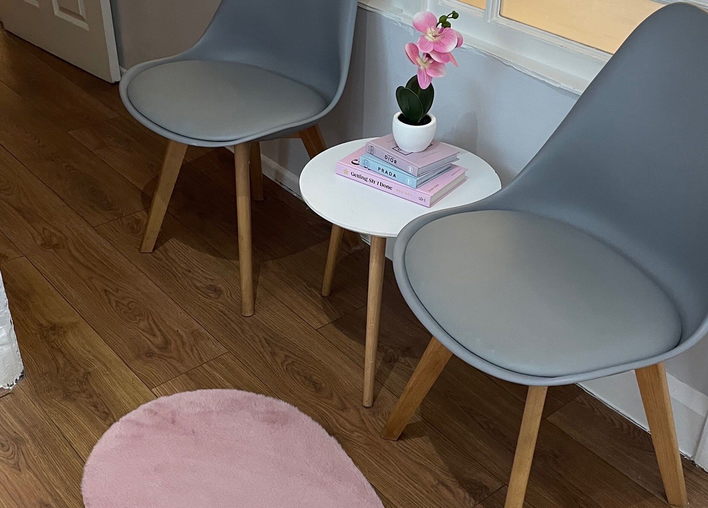 A serene waiting area at Nails by Kate Kennedy in Huddersfield, England, GB with chairs and a small table.