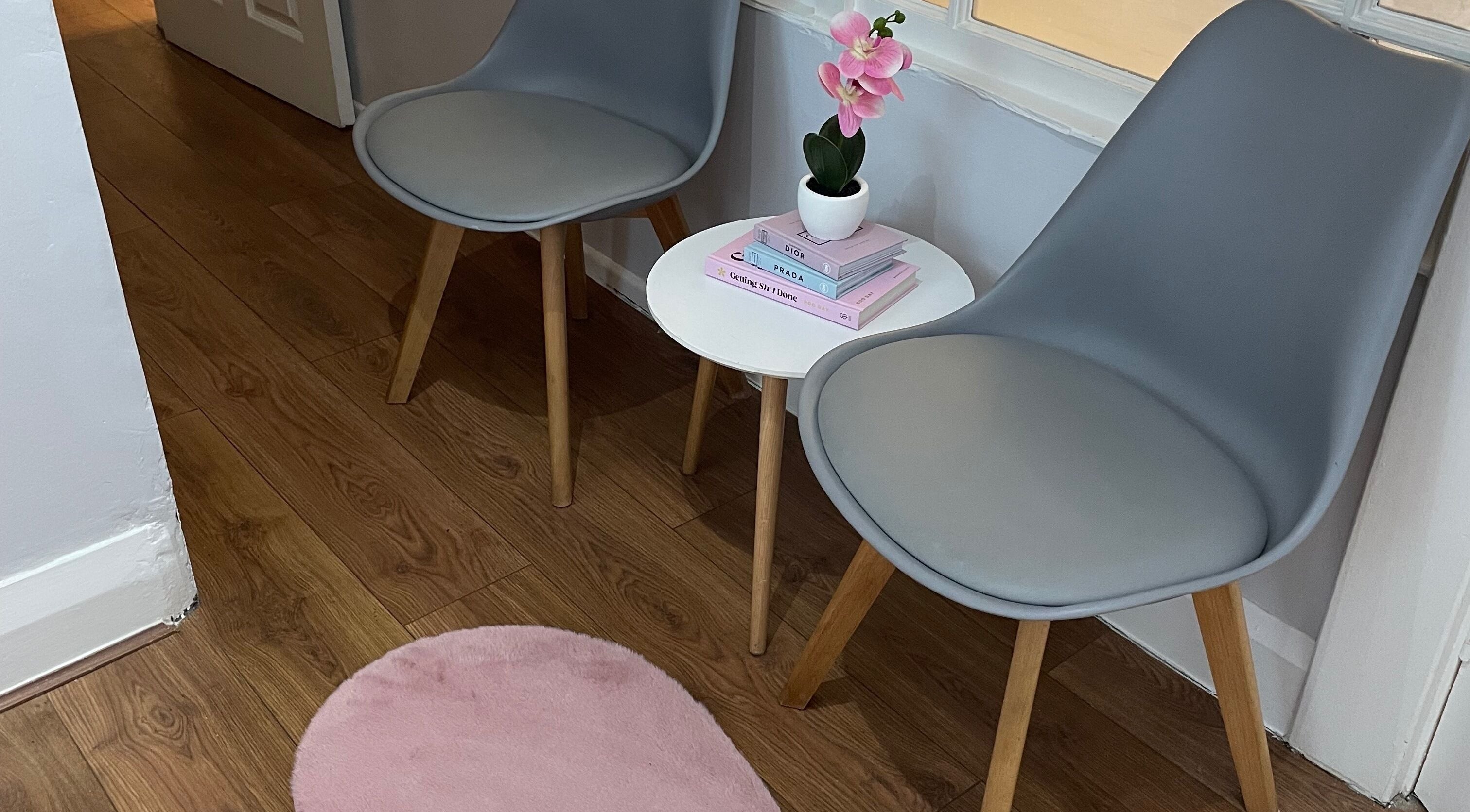 A serene waiting area at Nails by Kate Kennedy in Huddersfield, England, GB with chairs and a small table.