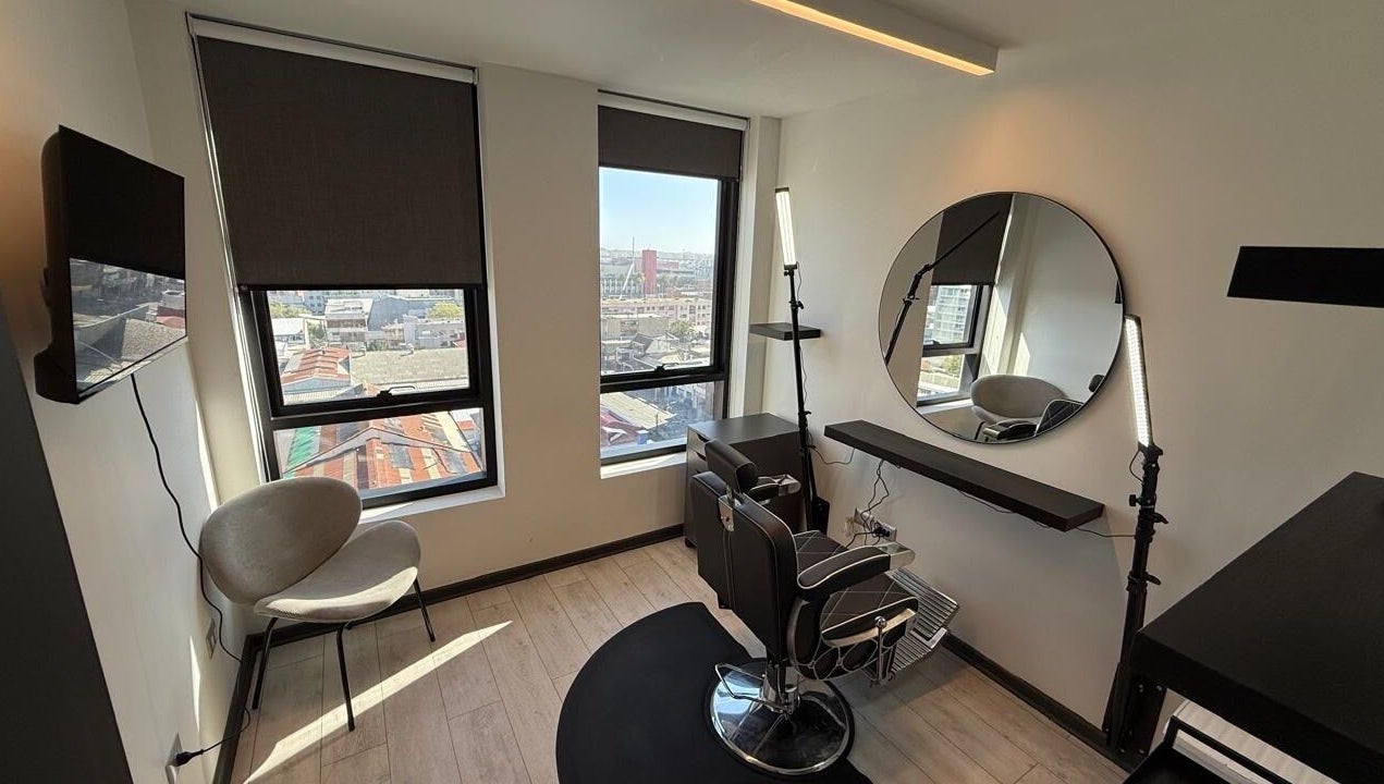 Elegante salón de belleza en VIBRA STUDIO, Concepción, Bío Bío, CL, con sillas modernas y vista panorámica.