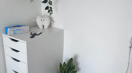 Stylish dental-themed decor at Pearl Bright in Reigate, England, GB with plush tooth and plant.