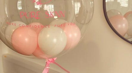 Decorative balloons at Pure SKNN, Warrington, England. Emphasizes elegance and confidence.