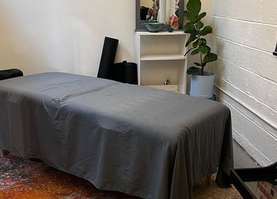 Cozy massage room at Christine Gonzalez Massage in Studio IX, Charlottesville, Virginia, US, with a tranquil setup.