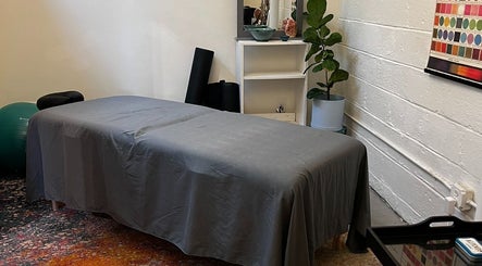 Cozy massage room at Christine Gonzalez Massage in Studio IX, Charlottesville, Virginia, US, with a tranquil setup.