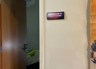 Entrance to Christine Gonzalez Massage at Studio IX, Charlottesville, Virginia, US, with open door and art decor.