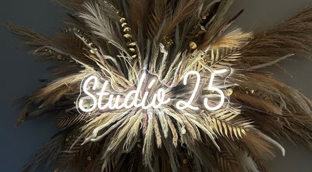 Studio 25 by Sadhbh glowing sign surrounded by pampas in Banagher, County Offaly, IE.