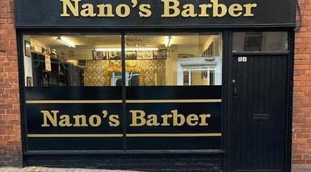 Front view of Nanos Barber in Enniscorthy, County Wexford, IE, showcasing stylish black and gold signage.