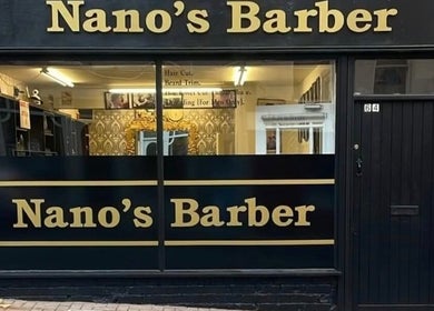 Front view of Nanos Barber at Enniscorthy, County Wexford, IE, showcasing stylish signage.