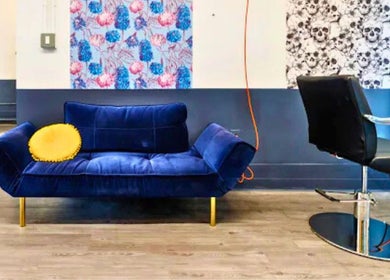 Blue sofa and salon chair in Prink’d Haus, New York, New York, US, showcasing modern design and bold colors.