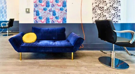 Blue sofa and salon chair in Prink’d Haus, New York, New York, US, showcasing modern design and bold colors.