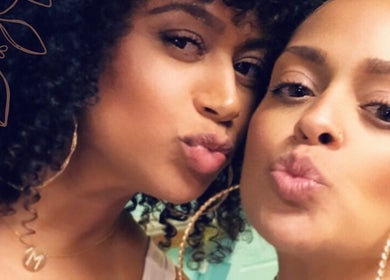 Two smiling women at Prink’d Haus in New York, exuding beauty and style with curly hairstyles.