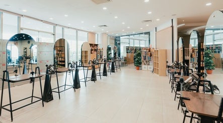 Modern interior of Kimage Salon in Singapore, Singapore, SG, showcasing sleek styling stations and large mirrors.