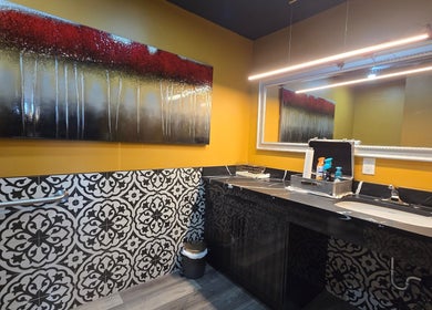 Chic restroom at Seoul Hair Salon, Calgary, Alberta, CA, with artistic decor and elegant vanity area.