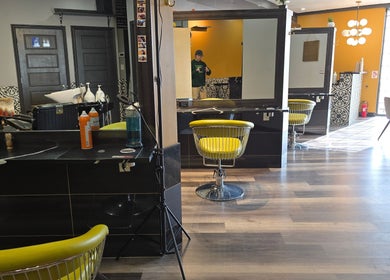 Modern interior of Seoul Hair salon in Calgary, Alberta, CA featuring bright yellow chairs and stylish decor.