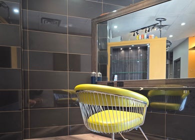 Modern chair and mirror at Seoul Hair salon in Calgary, Alberta, CA, showcasing sleek interior design.