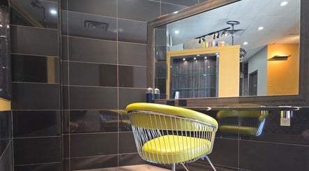 Modern chair and mirror at Seoul Hair salon in Calgary, Alberta, CA, showcasing sleek interior design.
