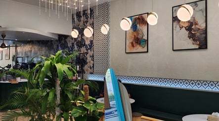 Elegant interior of Mimpi Headspa & Salon, Kuala Lumpur, showcasing modern decor and lush greenery.